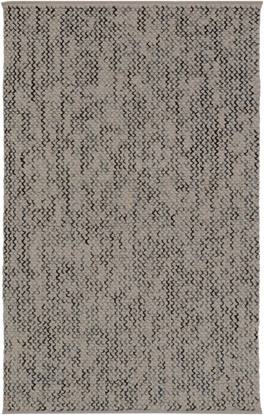 Close-up of the hand woven Hansell Area Rug. Features a charcoal, ice blue, and ivory geometric pattern. Design-Rectangle-576