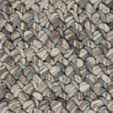 Close-up of the hand woven Hansell Area Rug. Charcoal, ice blue, and ivory wool create a textured, braided pattern. Swatch