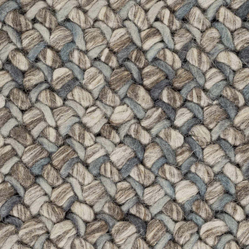 Close-up of the hand woven Hansell Area Rug. Charcoal, ice blue, and ivory wool create a textured, braided pattern. Swatch