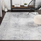 Living room scene with a light gray Hardeeville Area Rug, black chair, and white pouf. Abstract pattern. Modern style. Roomscene-Rectangle