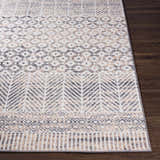 Close-up of Hassocks Area Rug showcasing charcoal, cream, and tan geometric patterns on a soft, textured weave. Front