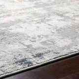 Close up of the Hayle Area Rug showing its charcoal, gray, and off white contemporary design and soft texture. Texture
