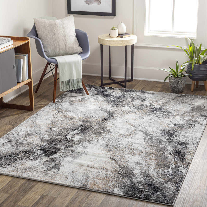 Living room scene with a Contemporary Marble Area Rug in black, gray, and ivory tones. Modern decor with chair, side table, and plants. Roomscene-Rectangle