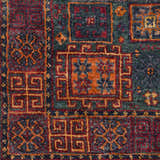 Close-up of the Herman Jute Carpet, showcasing its hand-knotted texture and traditional pattern in burnt orange, red, and dark green. Swatch