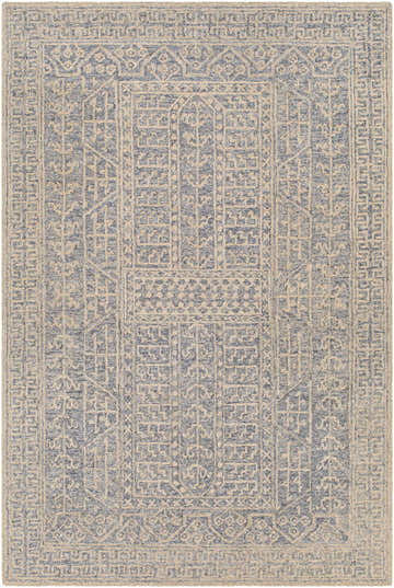 Close-up of the Hinton Wool Area Rug featuring a geometric, bohemian pattern in blue and beige tones. Design-Rectangle-69