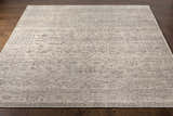 Close-up of the beige Hollym Premium Rug showing its traditional, hand-knotted design and subtle charcoal pattern. Front