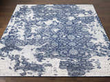 Close-up of the Holmes Carpet - Clearance rug. Hand-knotted wool rug in ivory, navy, and slate with a vintage bohemian pattern. Front