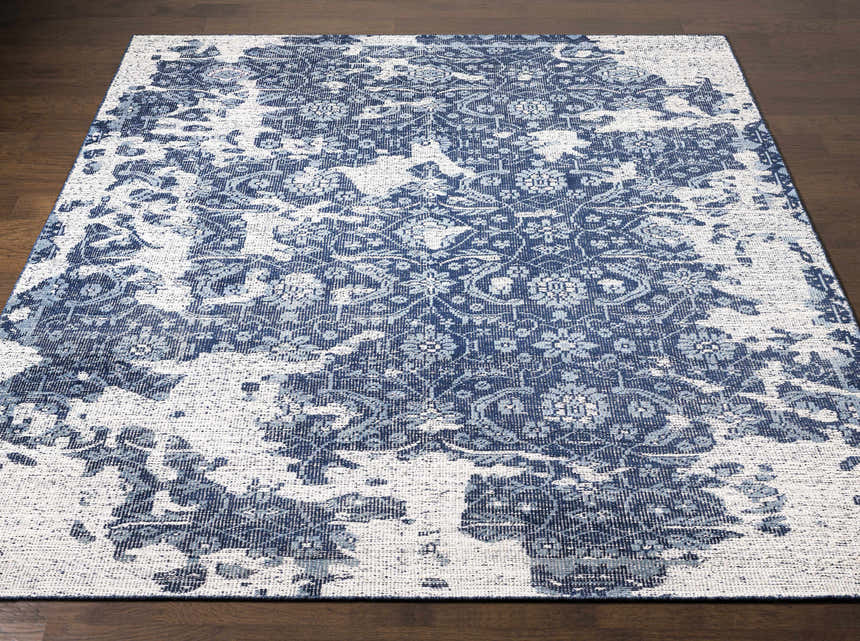 Close-up of the Holmes Carpet - Clearance rug. Hand-knotted wool rug in ivory, navy, and slate with a vintage bohemian pattern. Front