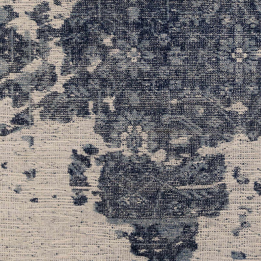 Close-up of the hand-knotted Holmes Carpet. Ivory and navy wool rug with a vintage, distressed bohemian pattern. Front
