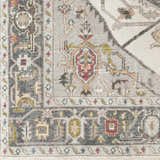 Close-up of the Halayhayin Premium Rug showing its traditional pattern, brick red, gray, cream, and brown colors. Hand-knotted texture. Swatch