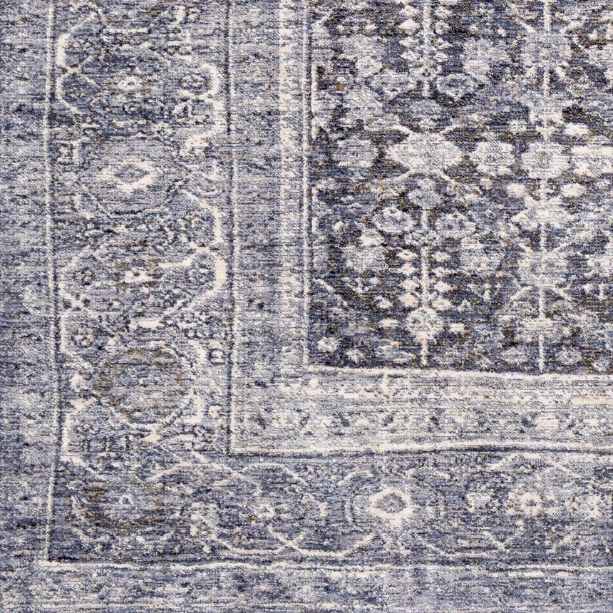 Close-up of the Housatonic Area Rug. Traditional oriental rug pattern in denim, light beige, navy, olive, pale blue, and white. Swatch