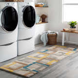 Bright laundry room with white washer/dryer and Harlech Area Rug runner in brown, blue, gray, ivory, and mustard. Roomscene-Runner