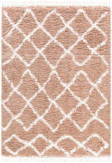 Close-up of the Hornsby Area Rug. Dusty pink shag rug with off-white geometric diamond pattern and tassels. Bohemian style. Design-Rectangle-5373