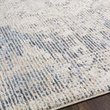 Close-up of Herricks Denim Medallion Area Rug showing cream, beige, and navy colors with a subtle, textured pattern. Texture