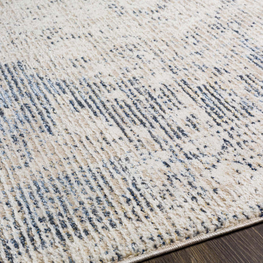 Close-up of Herricks Denim Medallion Area Rug showing cream, beige, and navy colors with a subtle, textured pattern. Texture