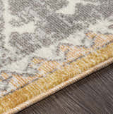Close-up of the Thornleigh Orange Medallion Area Rug showing its texture, medallion pattern, and orange, gray, and ivory colors. Texture