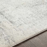 Close-up of the Hulme Gray Marble Luxe Rug, showing its light beige and gray tones and subtle marble pattern. Texture