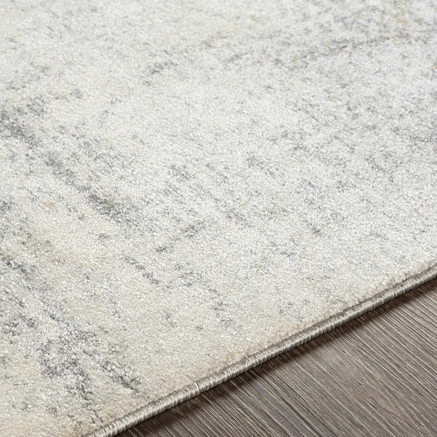 Close-up of the Hulme Gray Marble Luxe Rug, showing its light beige and gray tones and subtle marble pattern. Texture