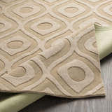 Close-up of the Hundred Area Rug. Tan wool rug features a modern geometric pattern with raised textures. Fold