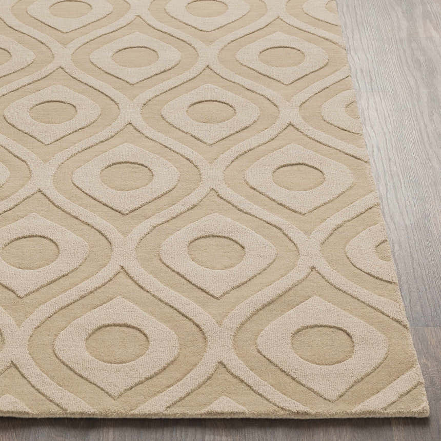 Close-up of the Hundred Area Rug in tan wool with a contemporary geometric pattern on a wood floor. Front