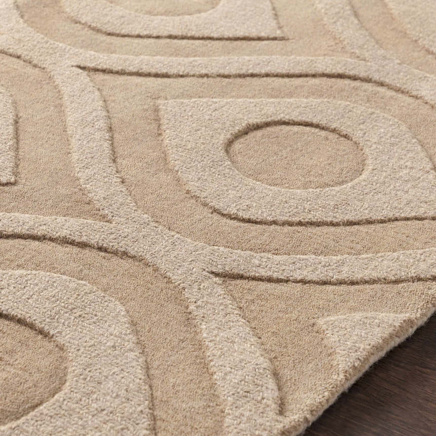 Close-up of the Hundred Area Rug. Tan wool rug with a contemporary, textured, geometric pattern. Texture