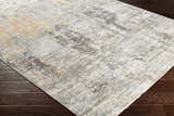 Close-up of the Hustontown Carved Statement Rug, showing its abstract pattern, and colors: gray, ivory, sage, charcoal, and orange. Corner