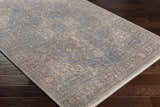 Close-up of the Akio Blue Area Rug showing the traditional pattern, light gray, blue, and mustard colors. Corner