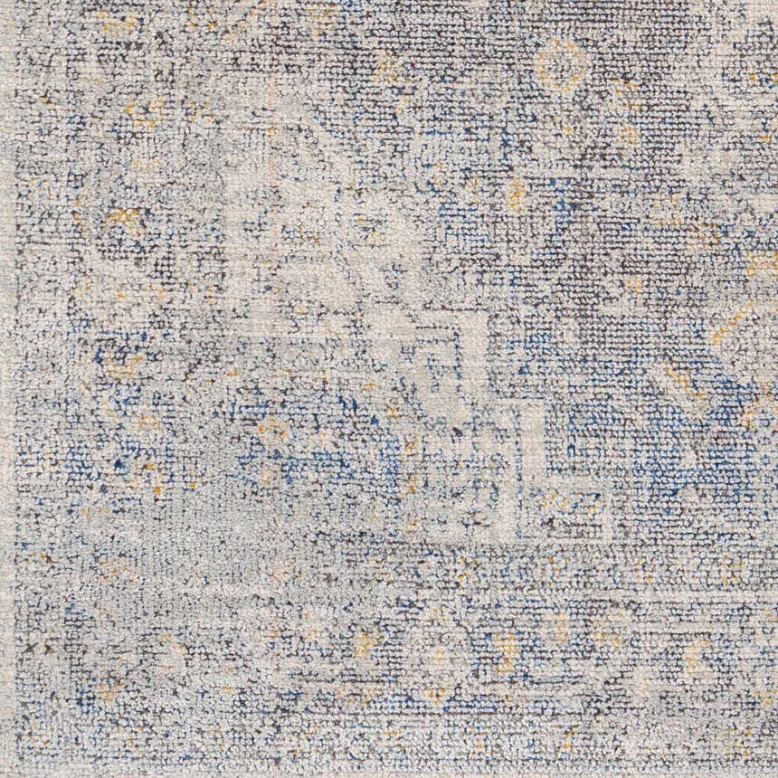 Close-up of the Akio Blue Area Rug. Machine-woven polyester rug with black, blue, ivory, and mustard colors. Swatch