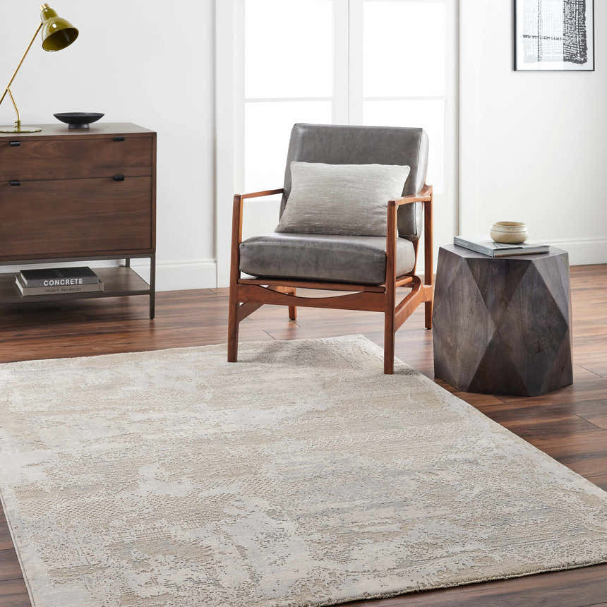 Living room scene with a gray chair and the Indah Thick Luxe Area Rug in cloud gray and light gray. Roomscene-Rectangle