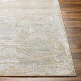 Close-up of Indah Thick Luxe Area Rug showing cloud gray, beige, and subtle pattern on dark wood floor. Front