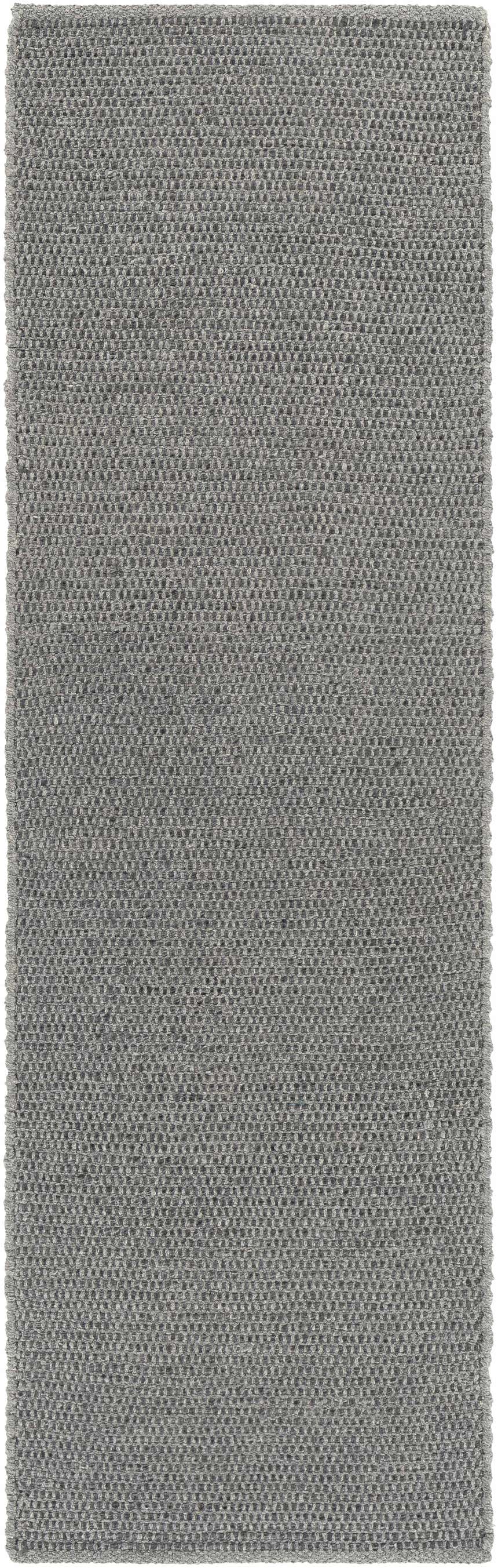 Close-up of the Innisfail Area Rug. Hand-woven rug in medium gray with a subtle, textured, solid and striped pattern. Design-Runner-268