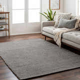 Living room scene with gray Innisfail Area Rug, beige sofa, wood floors, and neutral decor. Contemporary style. Roomscene-Rectangle