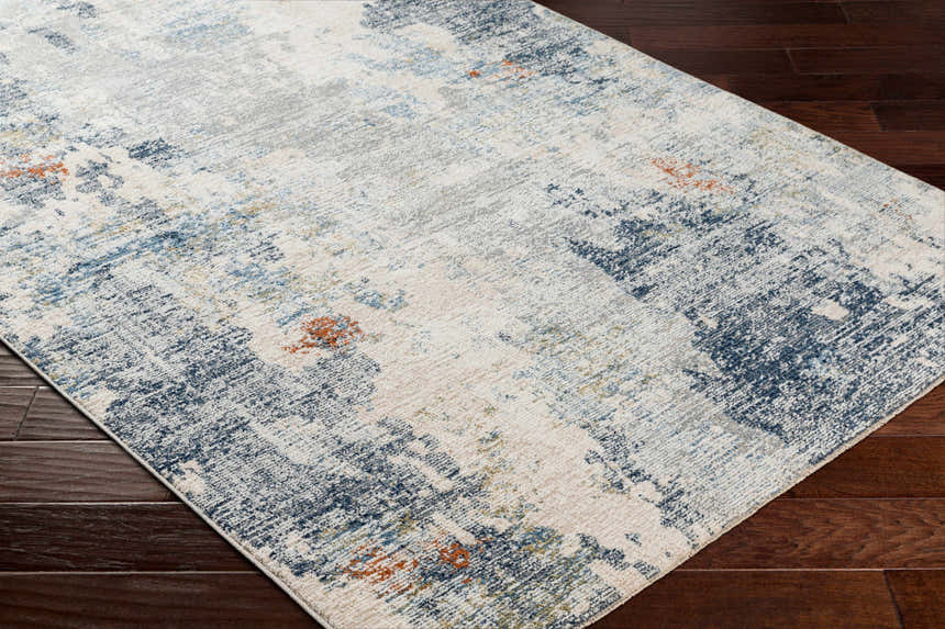 Close-up of the Iryna Area Rug showing its charcoal, brown, gray, and nutmeg contemporary design. Corner