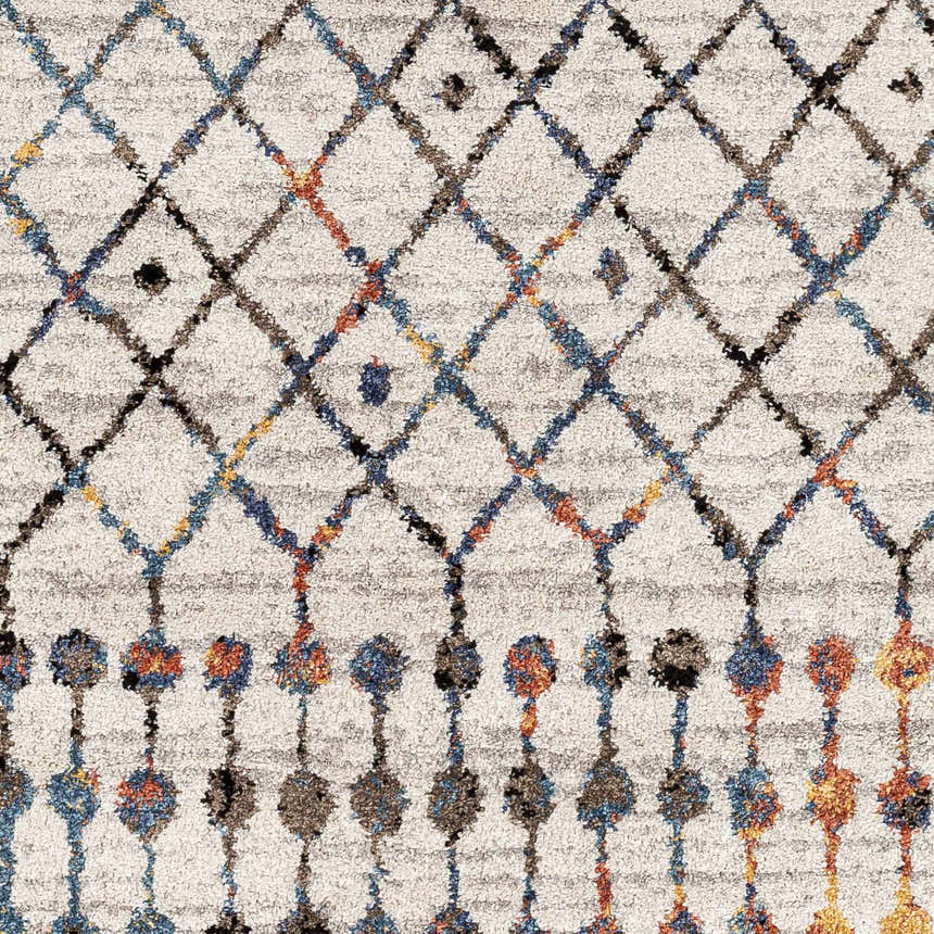 Close-up of the Itogon Area Rug. Geometric diamond pattern in black, brick red, burnt orange, teal, and gray on a light gray base. Swatch