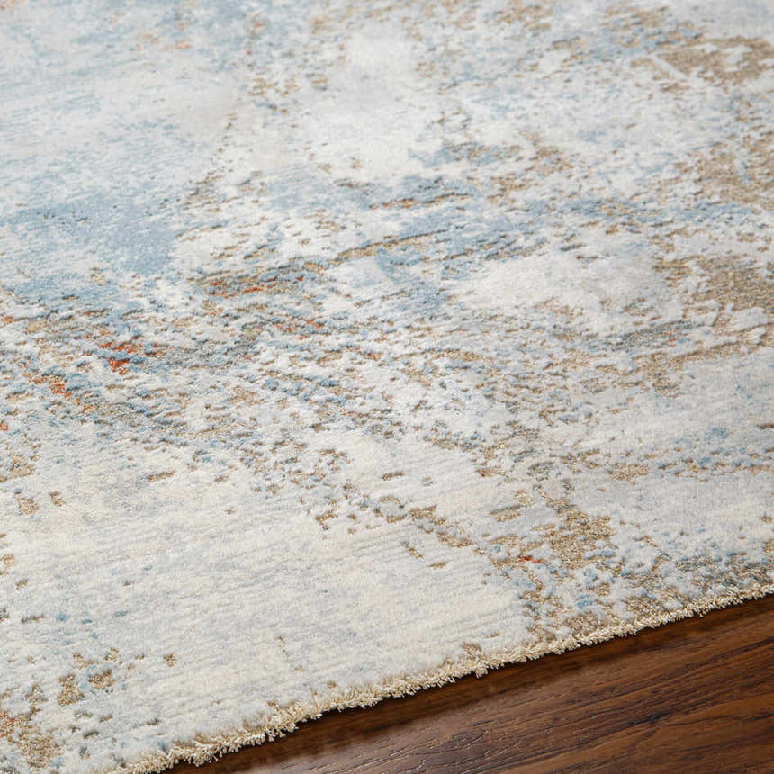 Close-up of the Jaela Thick Luxe Area Rug showing its light gray, brown, and blue contemporary pattern and soft texture. Texture