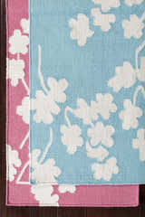 Close up of the hand woven Johnstown Area Carpet in light beige, rose, and white floral pattern. Styleshot