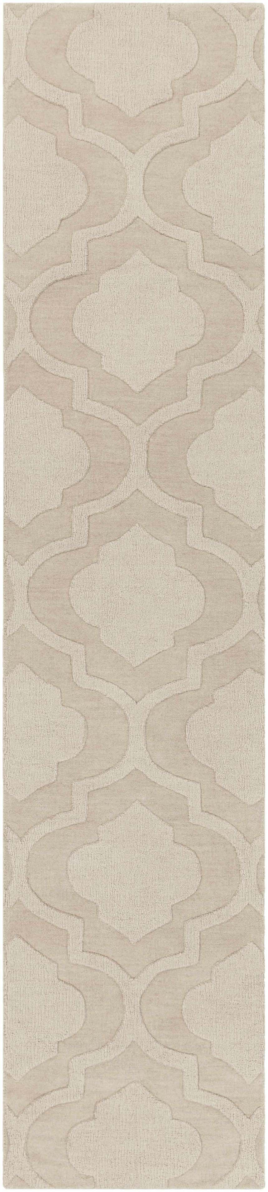 Close-up of the tan Kake Carpet, a hand-loomed wool rug with a contemporary geometric pattern. Neutral tones. Design-Runner-310