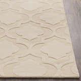 Close-up of the Kake Carpet in tan. Hand-loomed wool rug features a contemporary geometric trellis pattern. Front