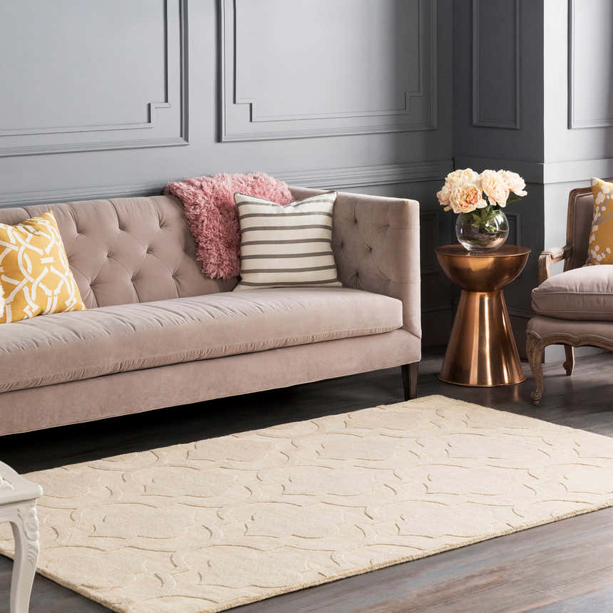 Living room scene with a tan Kake Carpet, gray sofa, and copper accent table. Contemporary style. Roomscene-Rectangle