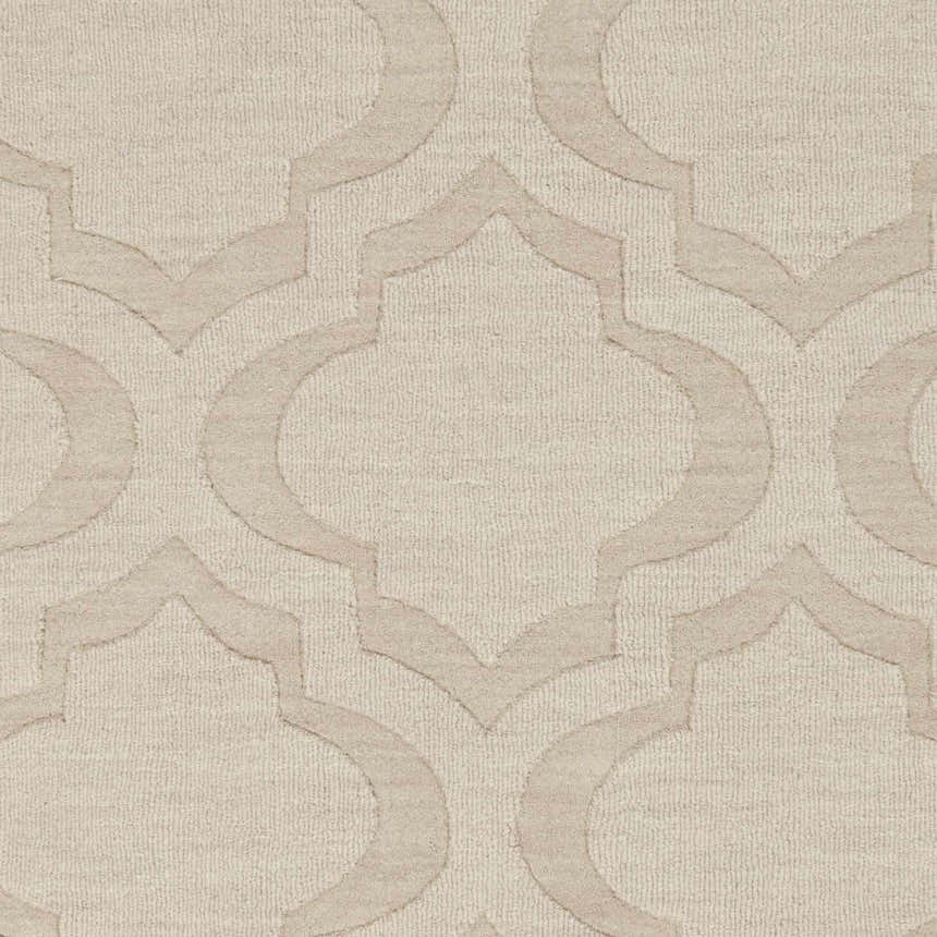 Close-up of the Kake Carpet showing a tan geometric trellis pattern on a cream wool texture. Swatch
