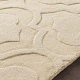 Close up of the tan, hand-loomed Kake Carpet showing its geometric pattern and wool texture. Texture