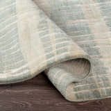 Close-up of the Kalaheo Premium Rug. Sage green wool rug with a contemporary design and hand-knotted construction. Fold