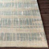 Close-up of the Kalaheo Premium Rug in sage. Features a contemporary striped pattern and hand-knotted wool texture. Front