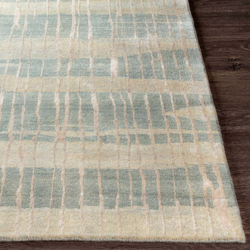 Close-up of the Kalaheo Premium Rug in sage. Features a contemporary striped pattern and hand-knotted wool texture. Front