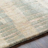 Close-up of the hand-knotted Kalaheo Premium Rug. Sage and cream wool rug with a contemporary geometric design. Texture