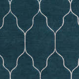 Close up of the teal Kamay Area Rug featuring a beige, hand-knotted, geometric trellis pattern. Swatch