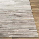 Close up of the Karabar Premium Area Rug showing beige, brown, and gray hair on hide stripes. Front