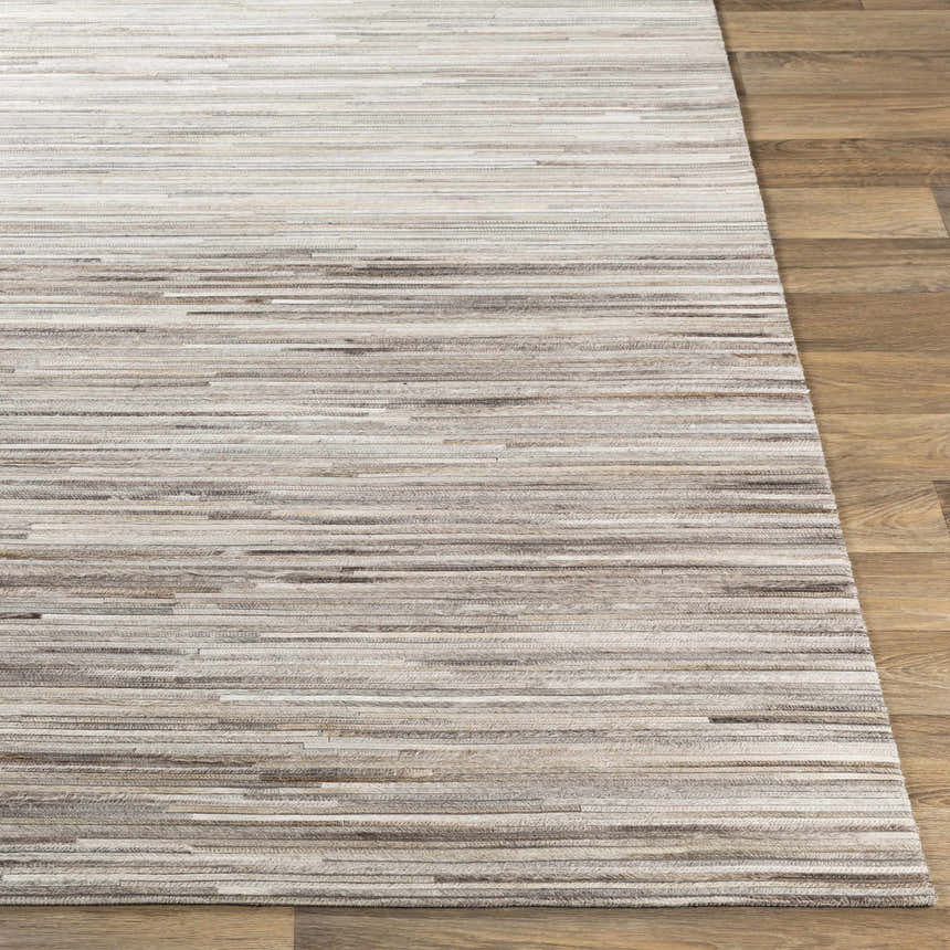 Close up of the Karabar Premium Area Rug showing beige, brown, and gray hair on hide stripes. Front