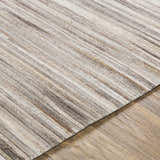 Close-up of the Karabar Premium Area Rug showing its hair on hide texture and beige, brown, and gray striped pattern. Texture