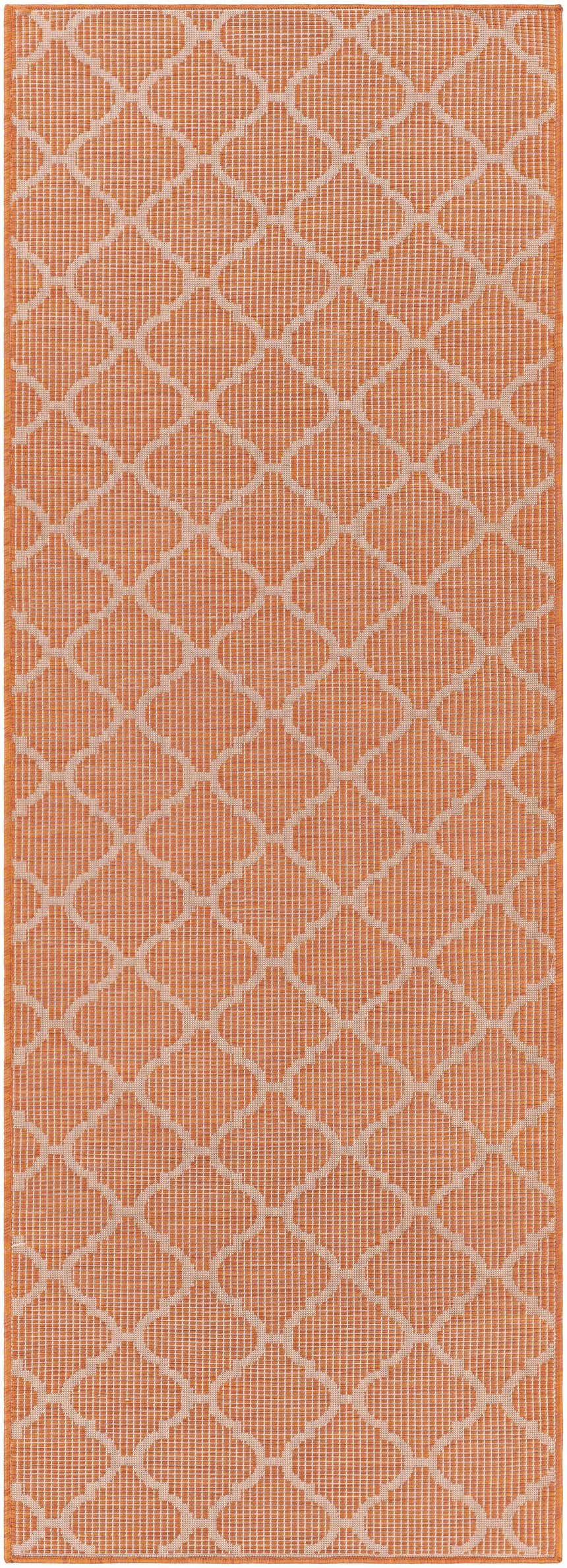Close-up of Unique Outdoor Trellis Area Rug, Rust Red. Burnt orange rug with a geometric trellis pattern. Contemporary style. Design-Runner
